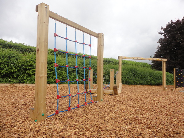 bark flooring and climbing playground equipment
