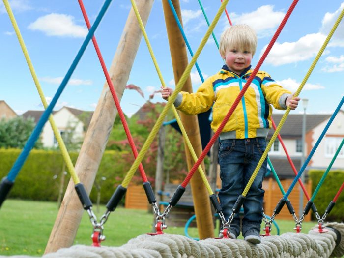 child using a rope swing in Aiskew Parish Council park playground
