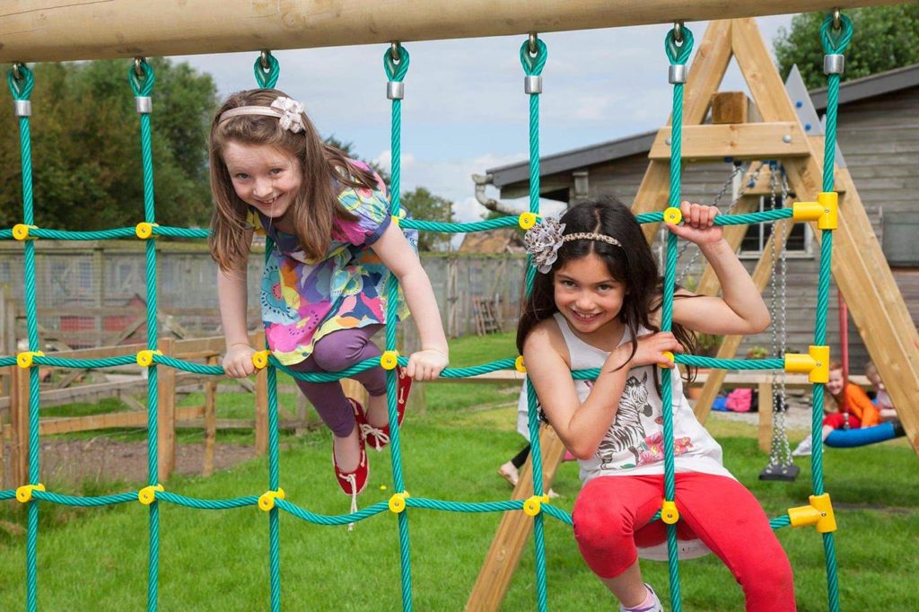 girls using equipment after successful playground installation